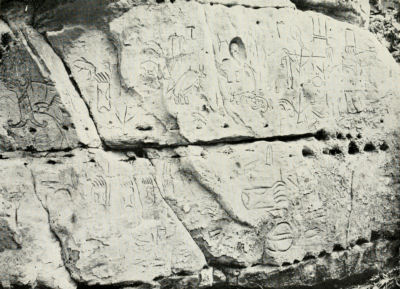 A large stone carved with petroglyphs.